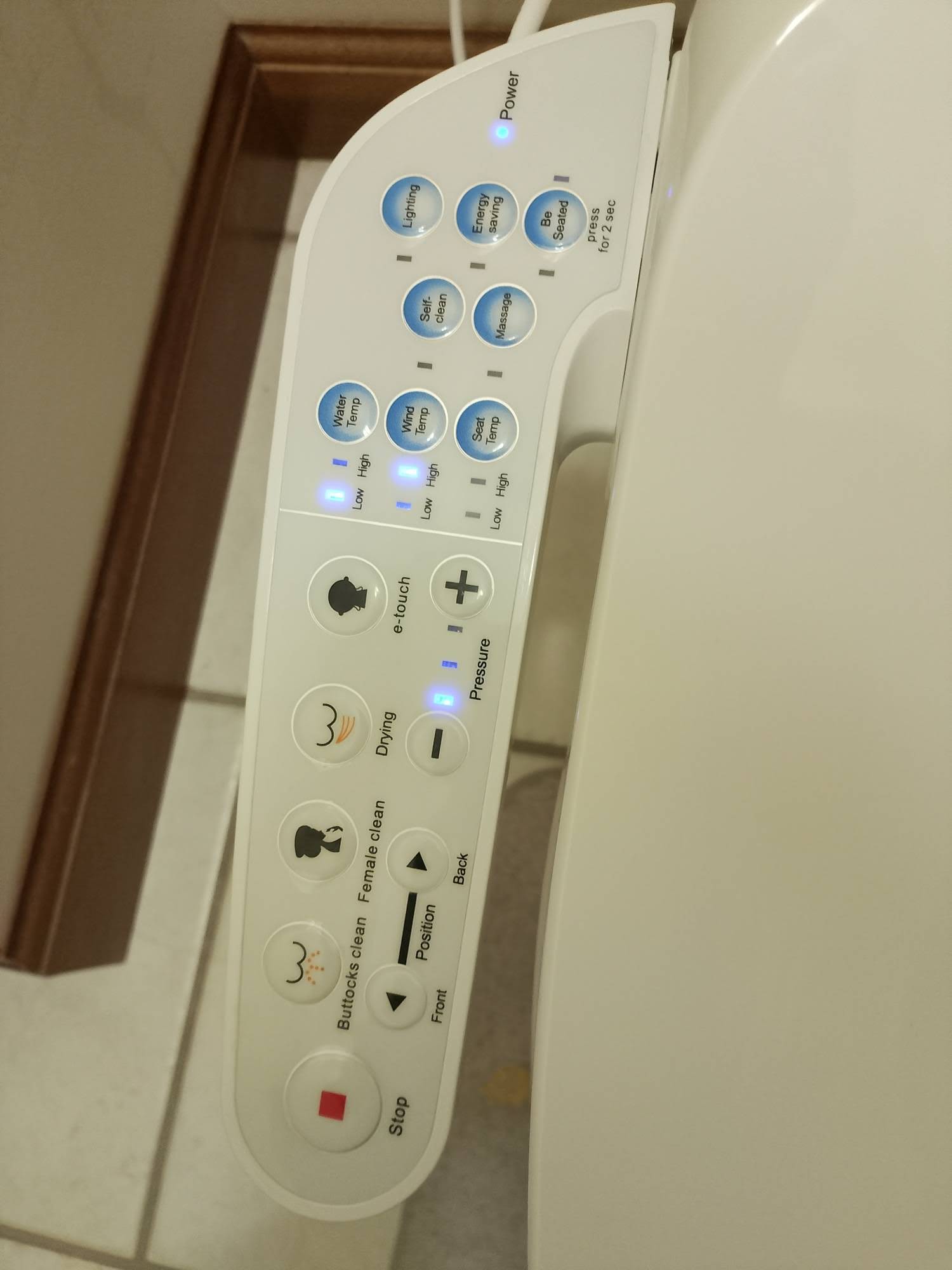 Close-up of the built-in side control panel on the electronic bidet toilet seat